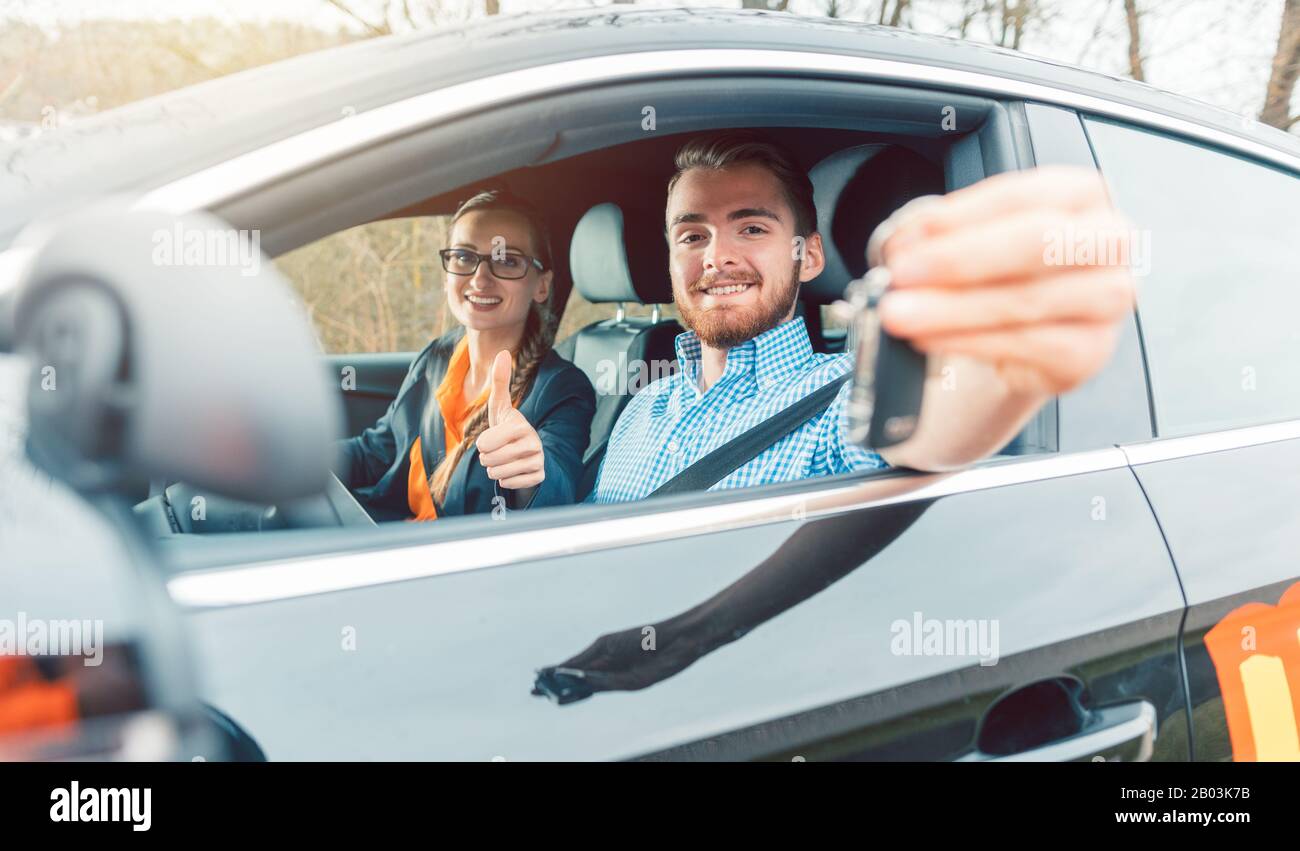 Student of driving school having passed his final test showing the car keys Stock Photo