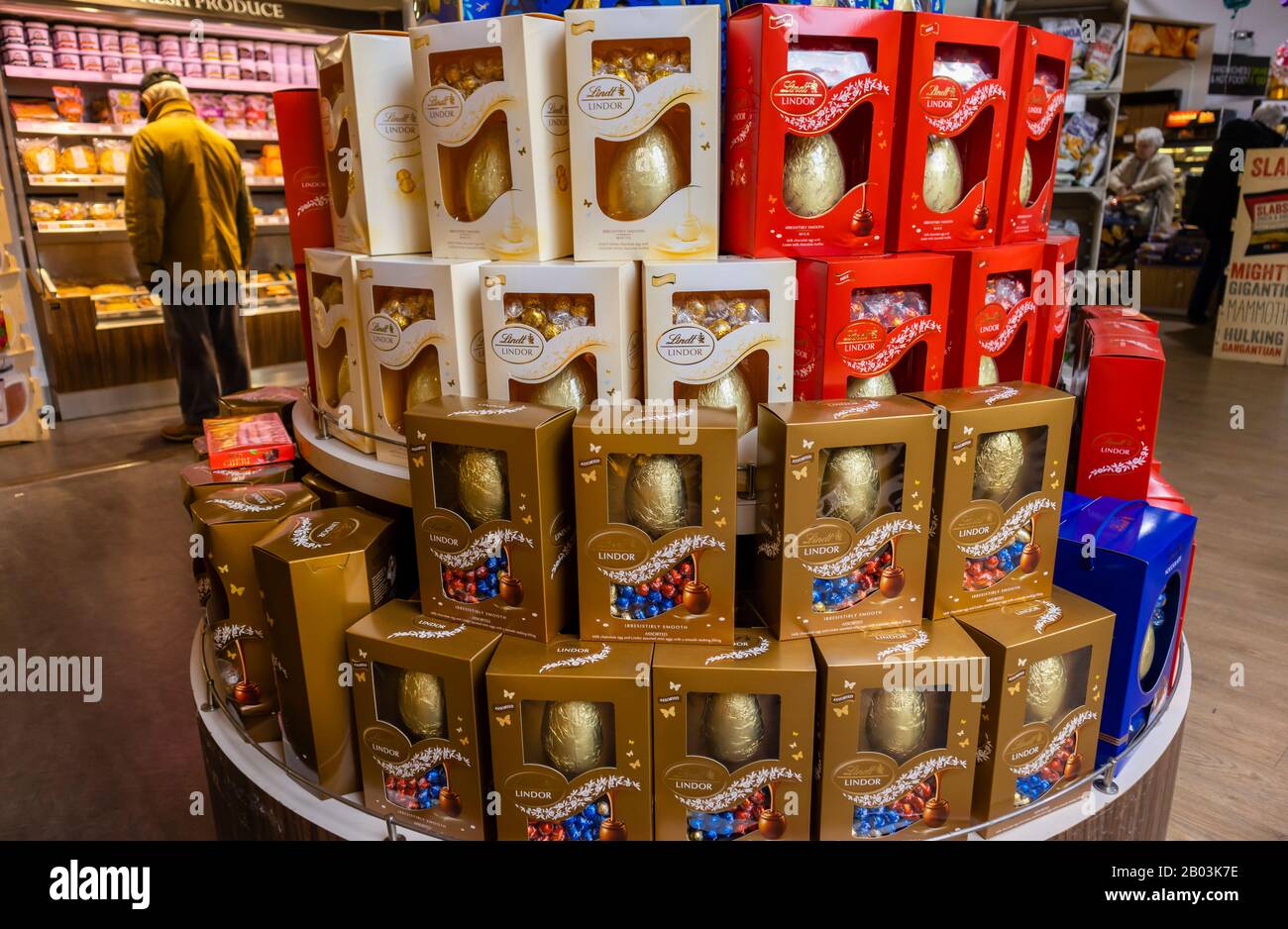 Display of a colourful stack of Lindt Lindor chocolate Easter eggs stacked up in a garden centre in south-east England Stock Photo