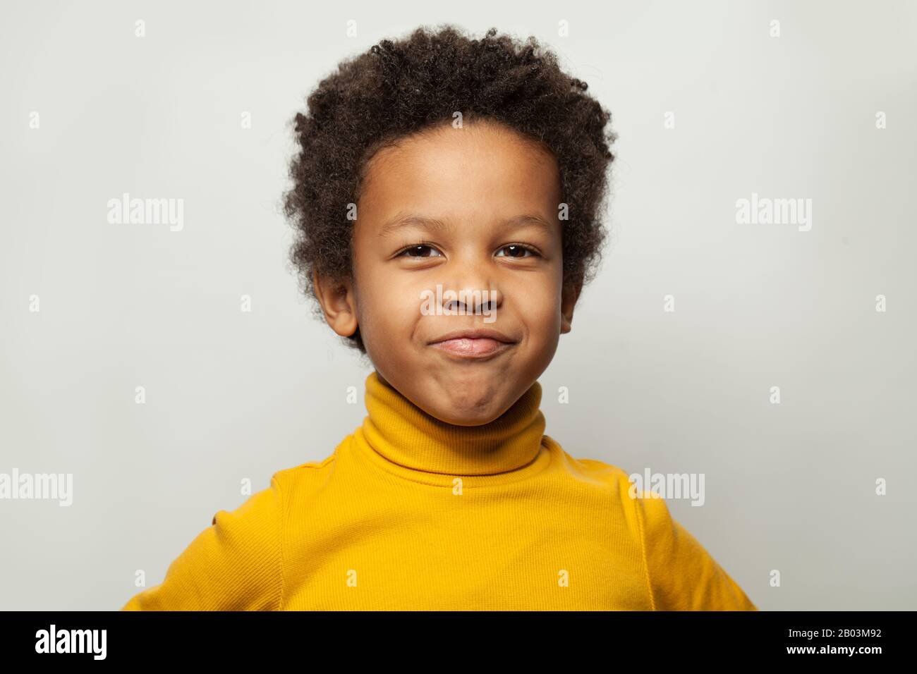 Funny black child boy grimacing on white background Stock Photo Alamy