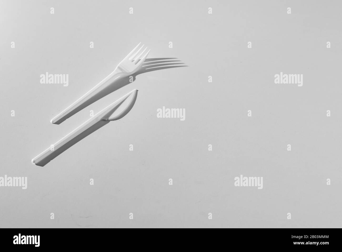 a top view conceptual minimalism with plastic table utensil tablewear cultery Stock Photo