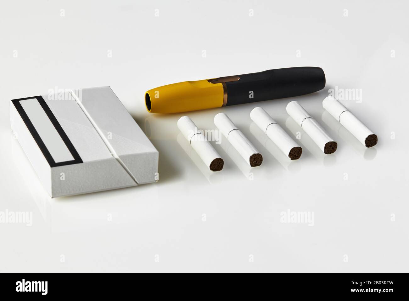 New generation black and yellow electronic cigarette, pack and five  heatsticks, isolated on white. New technology. Tools used to help stop  smoking. He Stock Photo