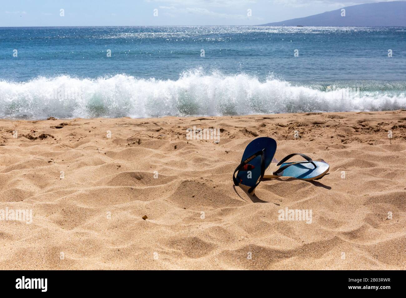 Flip flops on a beach Stock Photo - Alamy