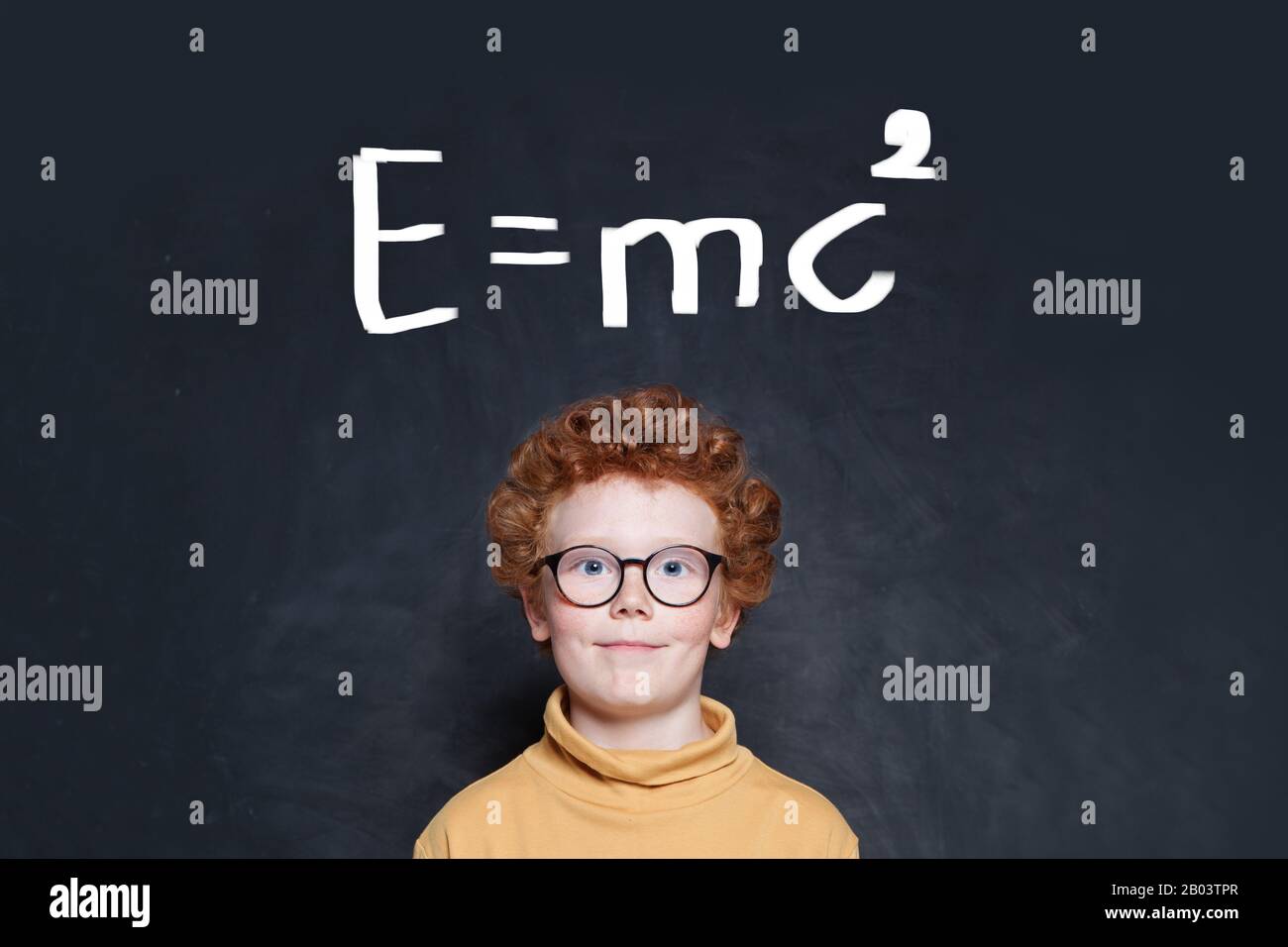 Curious kid boy wearing glasses on background with science formula Stock Photo