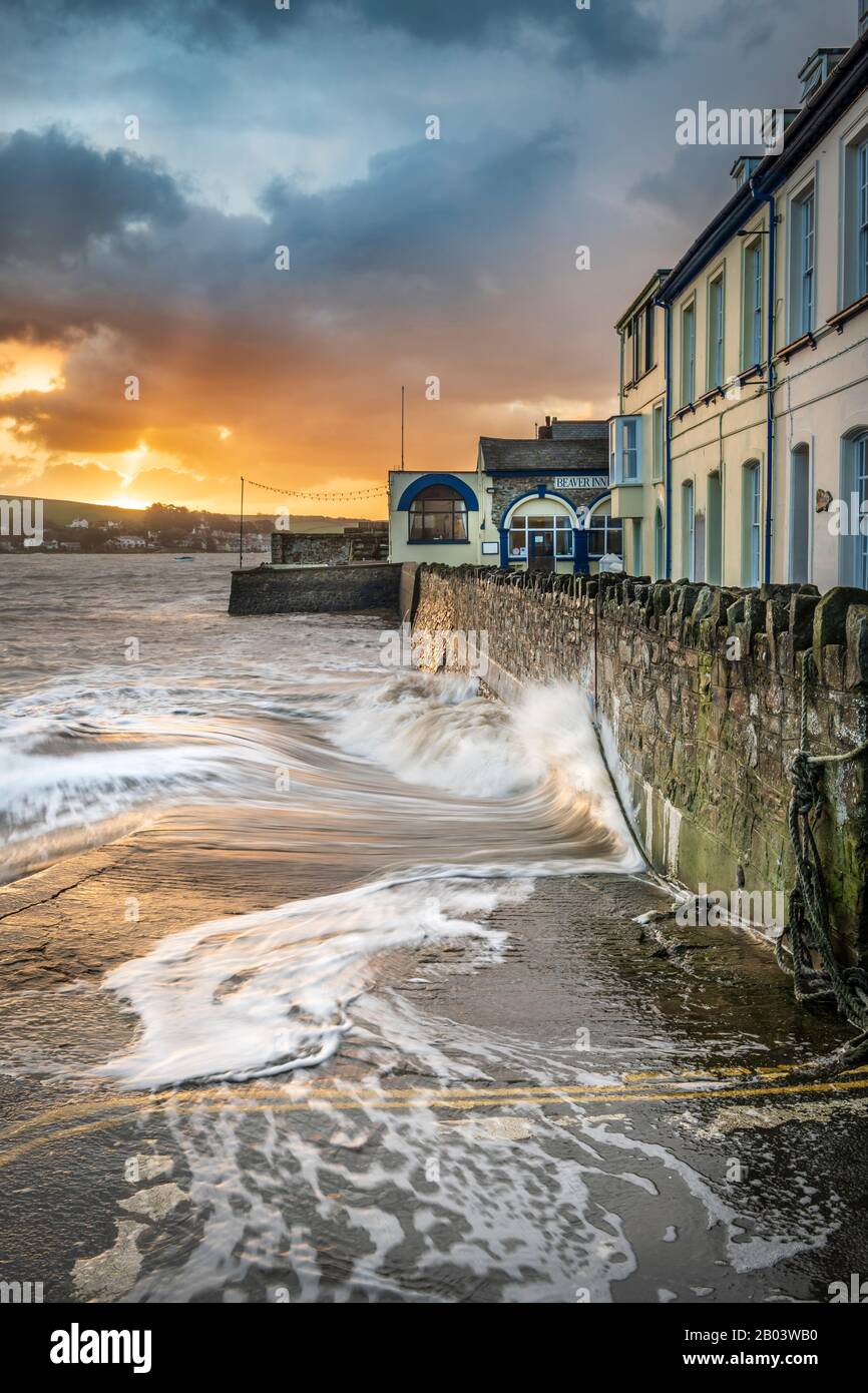 High tide on the River Torridge sees waves crash against  the seawall at West Quay in Appledore, North Devon. Stock Photo