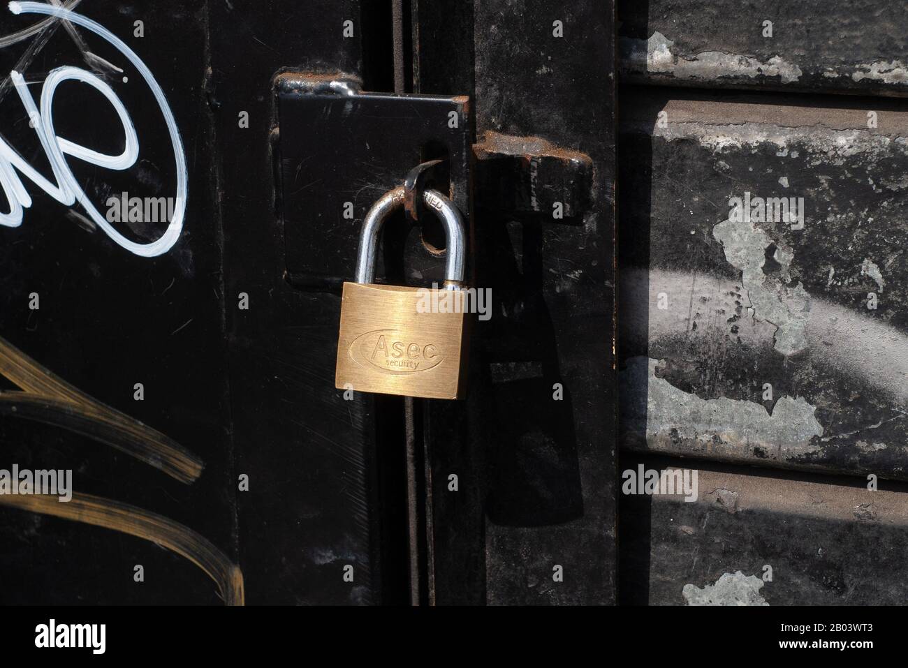 metal shutter on a locked up shop with spray paint Stock Photo Alamy