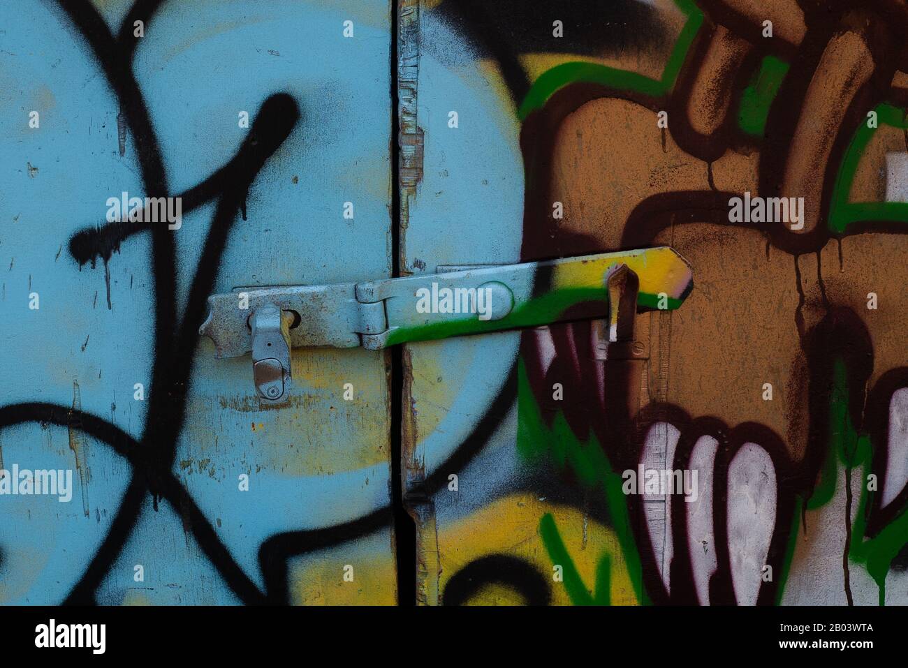 metal shutter on a locked up shop with spray paint Stock Photo Alamy