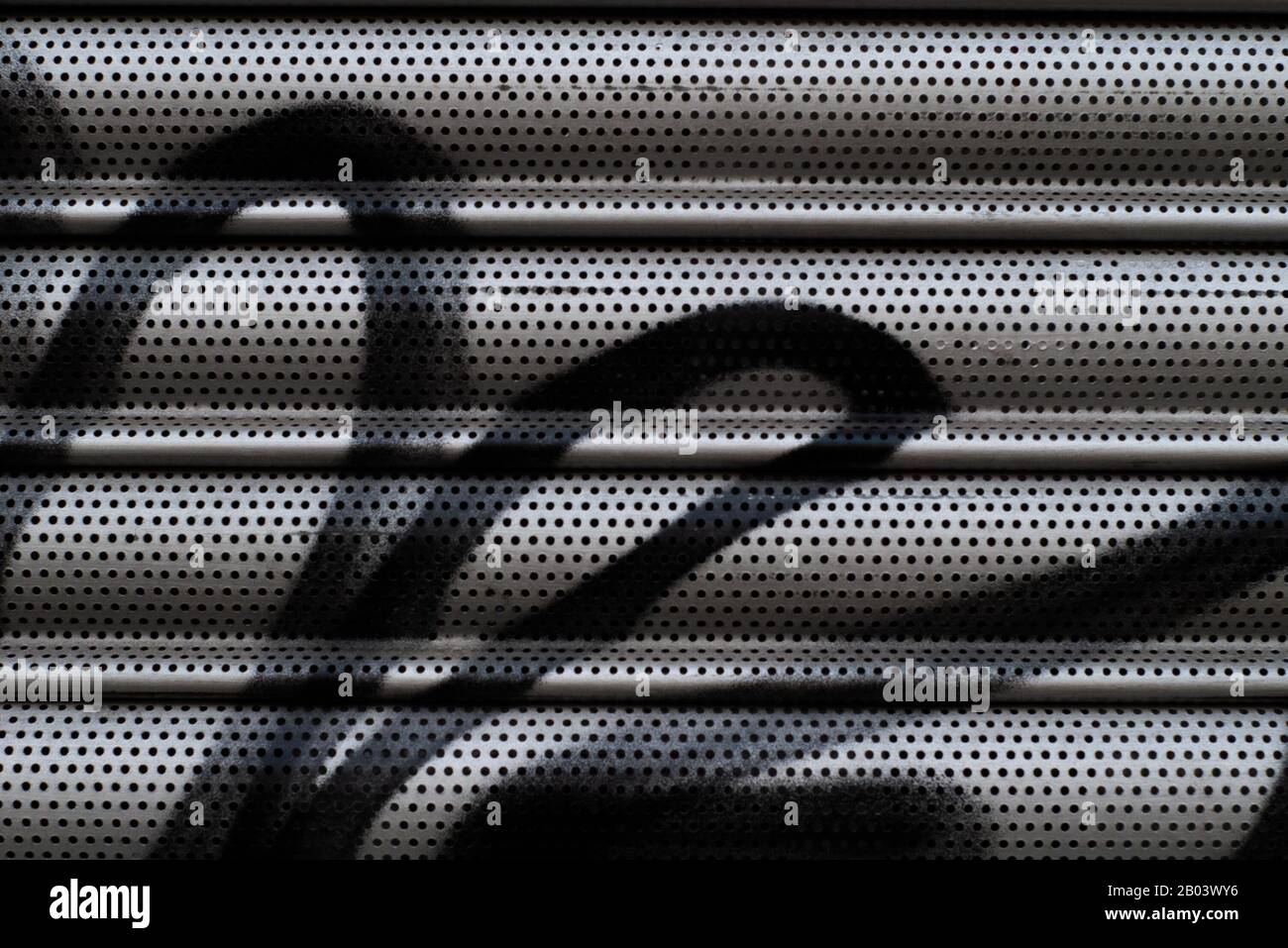 metal shutter on a locked up shop with spray paint Stock Photo Alamy