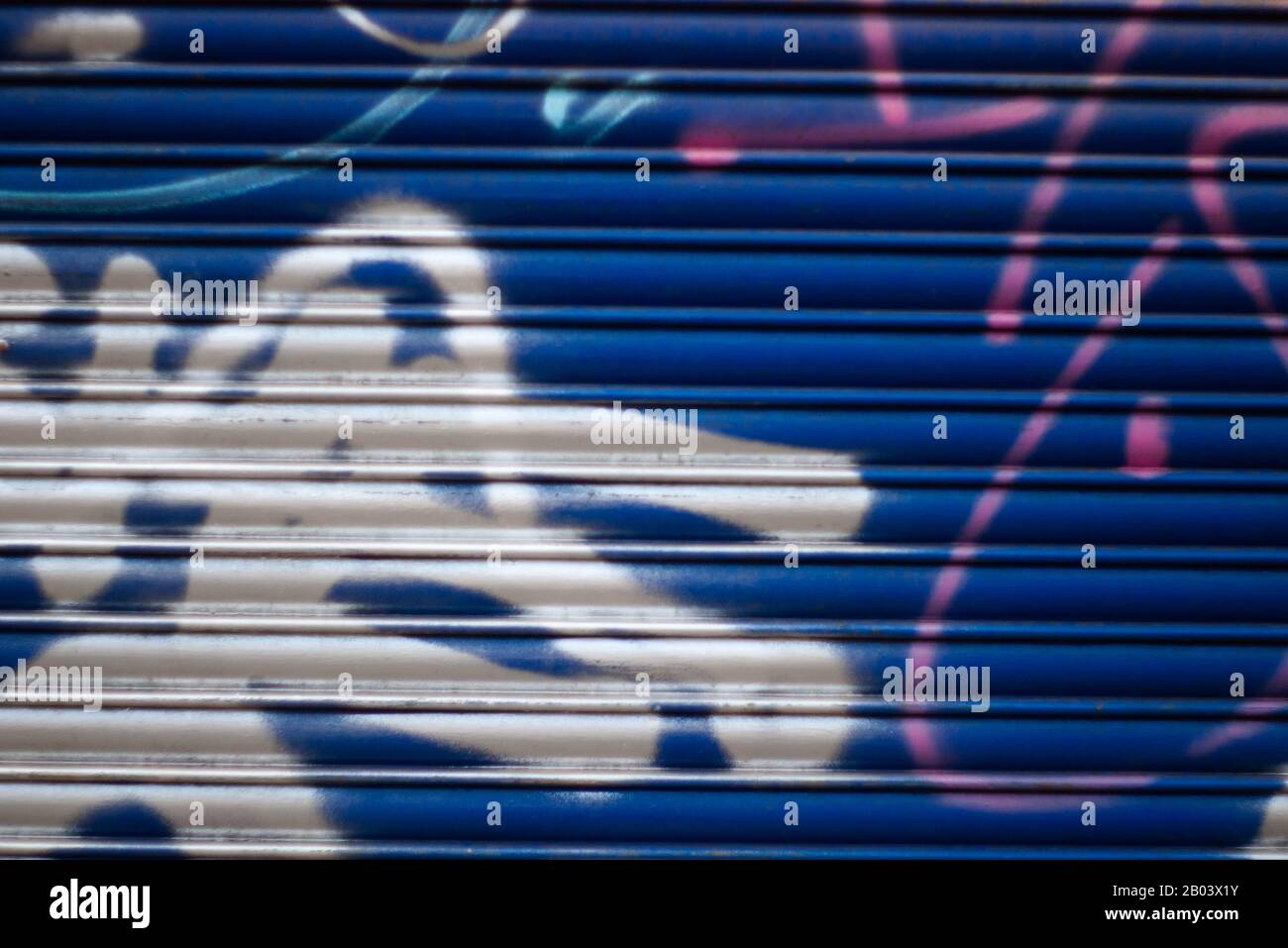 metal shutter on a locked up shop with spray paint Stock Photo Alamy