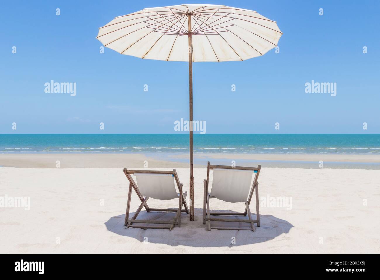 Idyllic tropical beach with white sand, turquoise ocean water and blue sky in huahin thailand Stock Photo