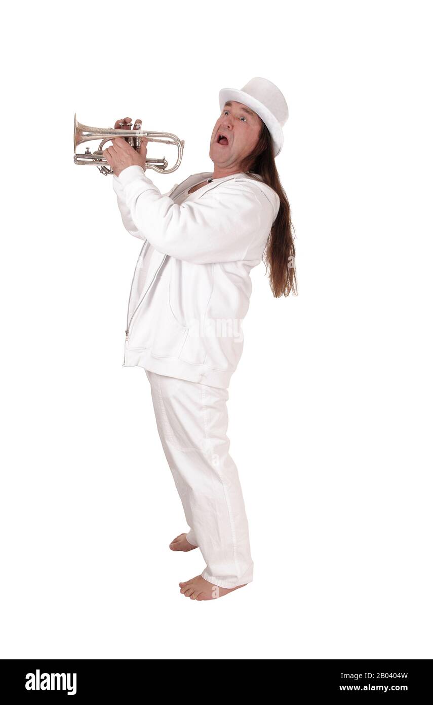 A middle age indigenous man standing in a white outfit and white hat playing his trumpet with his long hair, isolated for white background Stock Photo