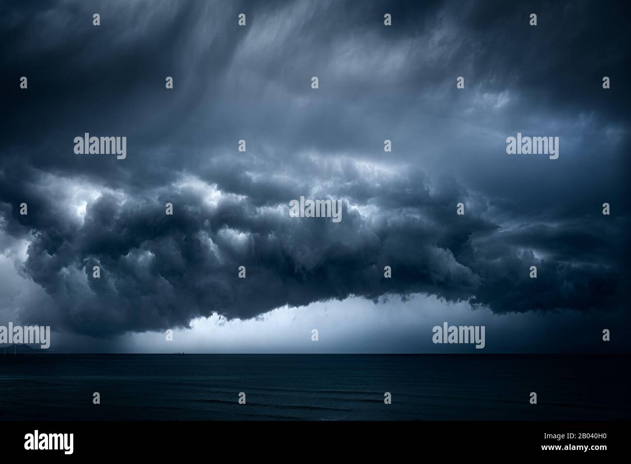 dark and dramatic stormy clouds over sea Stock Photo