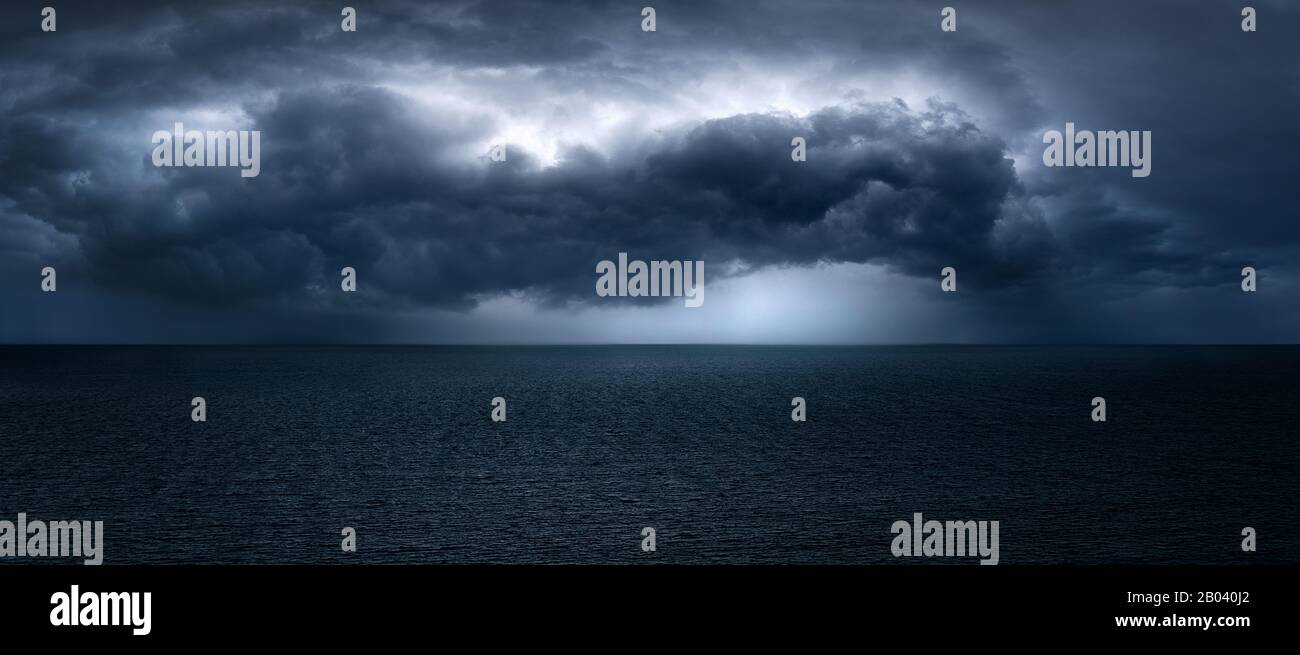 dark and dramatic stormy clouds over sea Stock Photo