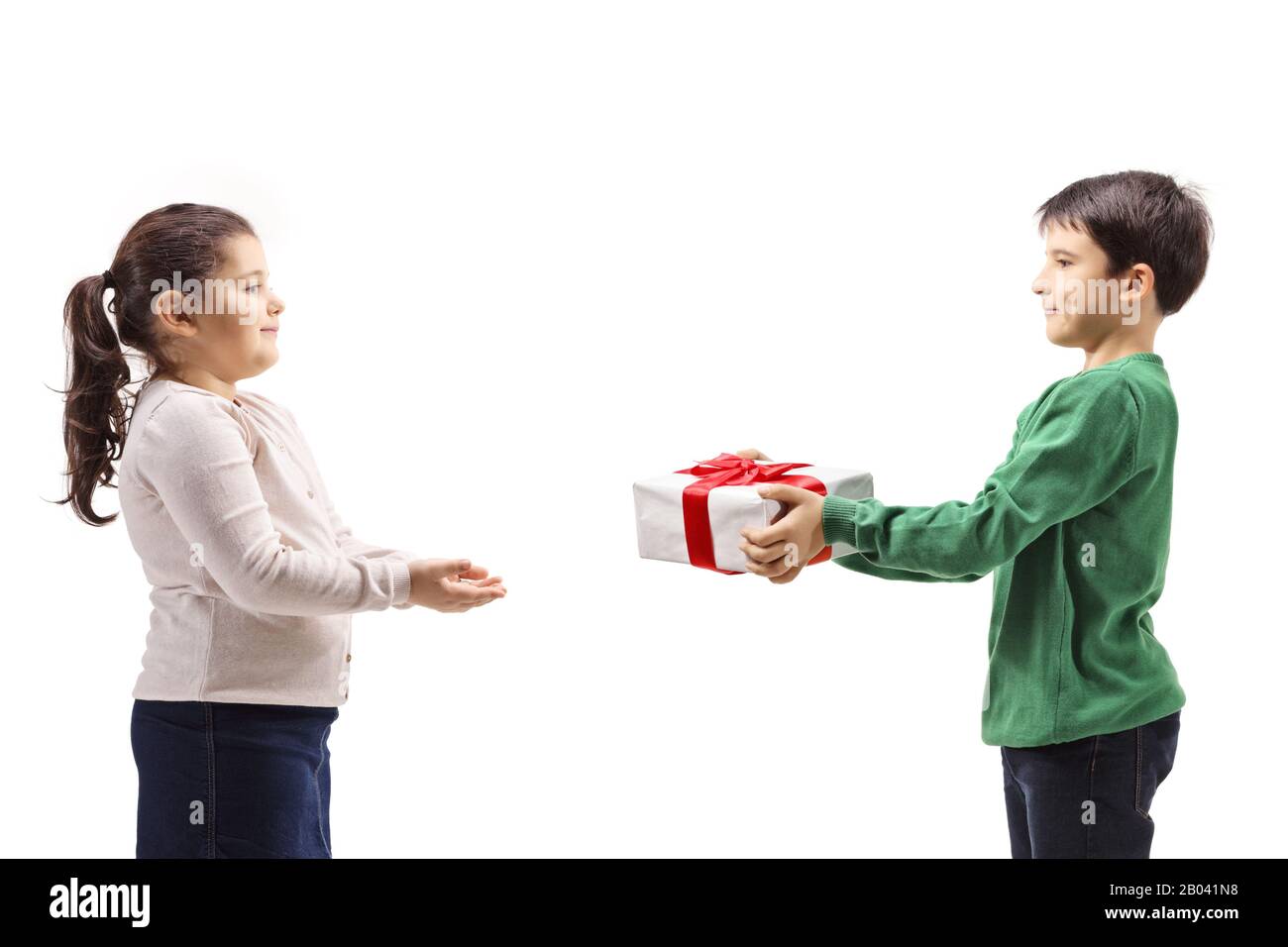 Boy giving a present to a girl isolated on white background Stock Photo