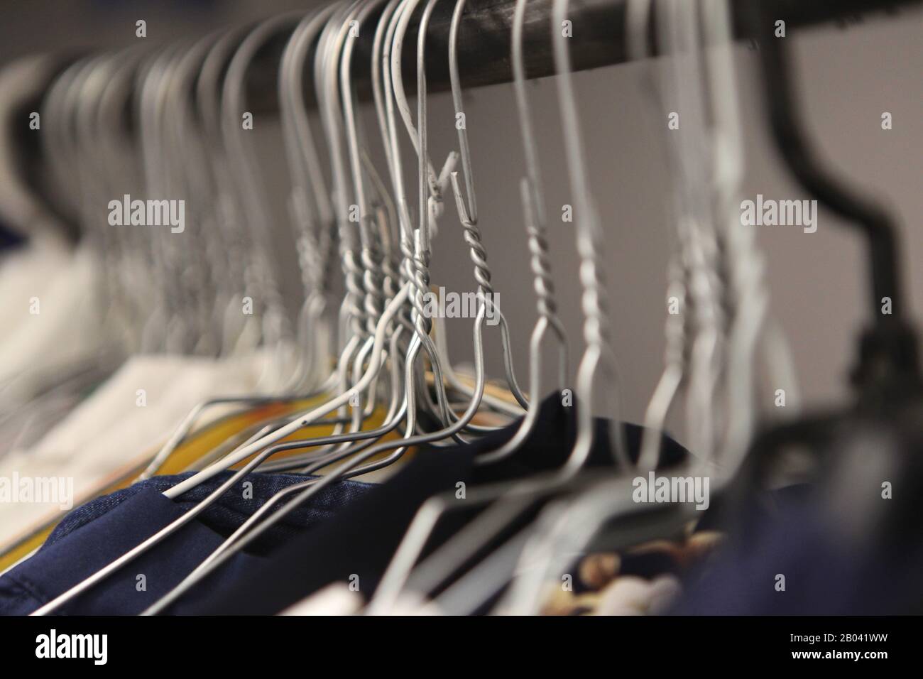 clothes hanger closeup of fashion shop. aluminium hanger with clothes