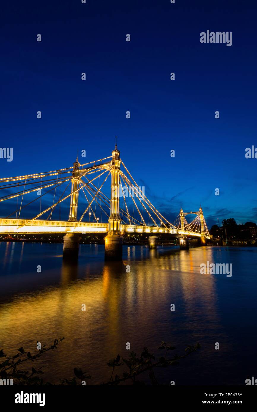 The Albert Bridge, London, at night with lights and sunset Stock Photo