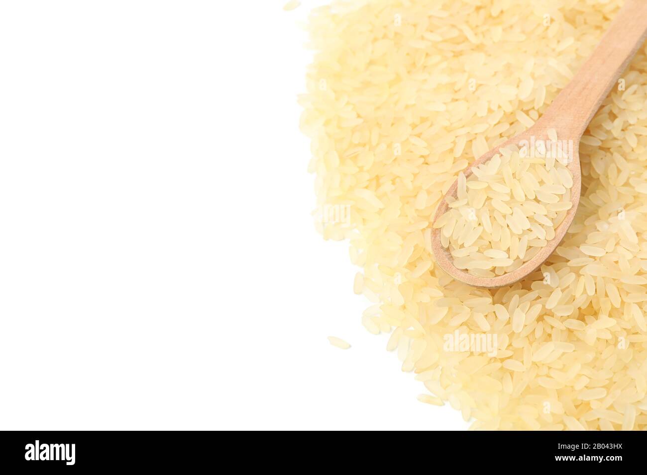 Wooden spoon and rice isolated on white background Stock Photo - Alamy
