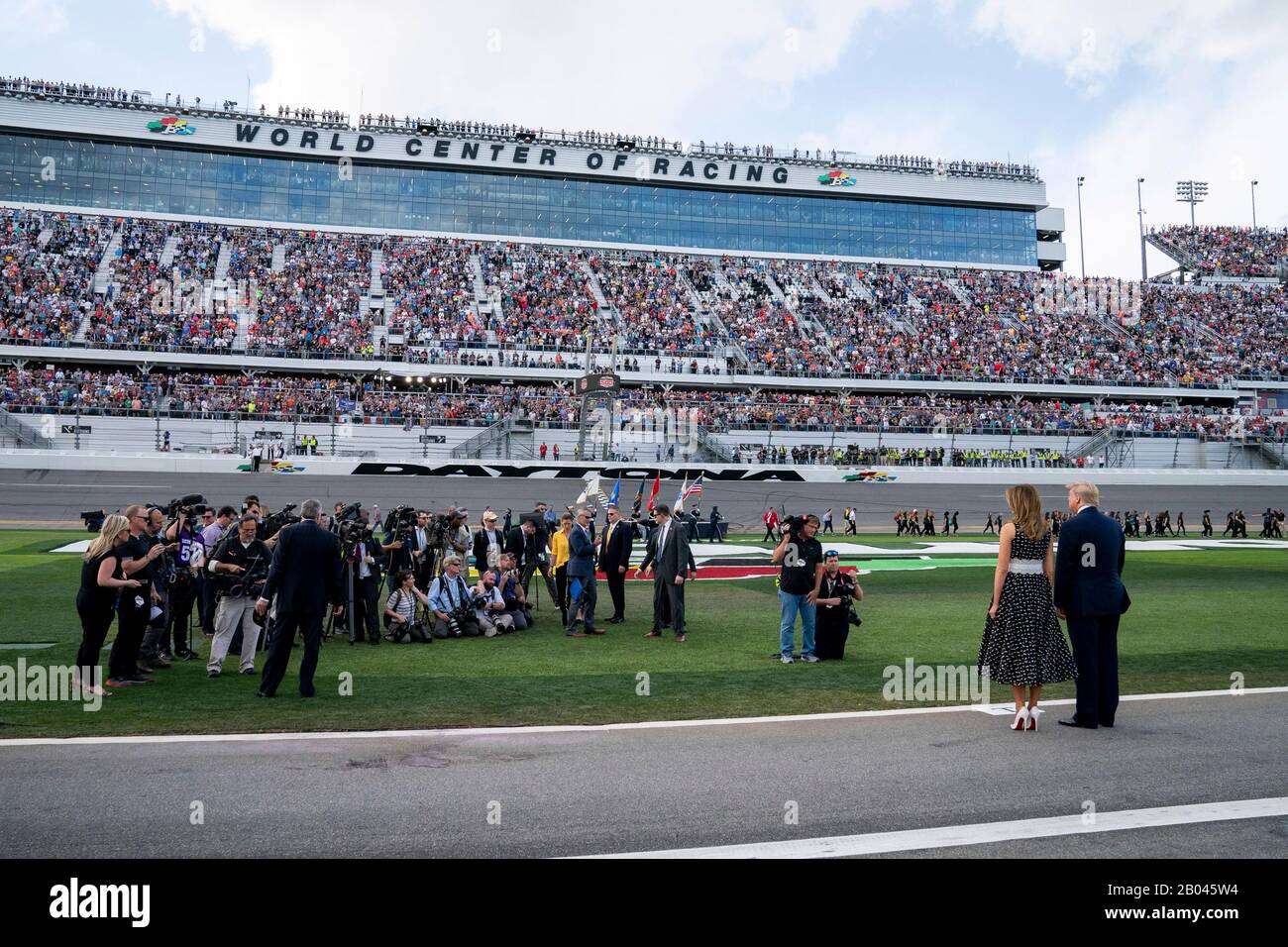 U.S President Donald Trump and First Lady Melania Trump, stand together on the track at Daytona International Speedway February 16, 2020 in Daytona Beach, Florida. Trump served as the official starter of the the NASCAR Daytona 500 auto race and took a ride in the presidential limousine around the track. Stock Photo