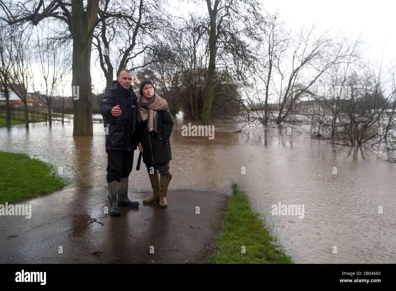Defra Environment Minister Rebecca Pow, and Anthony Perry, West Midlands Operations Manager at the Environment Agency look at the swollen river in Worcester from the Hylton road flood defences after the river Severn burst its banks in the aftermath of Storm Dennis. Stock Photo