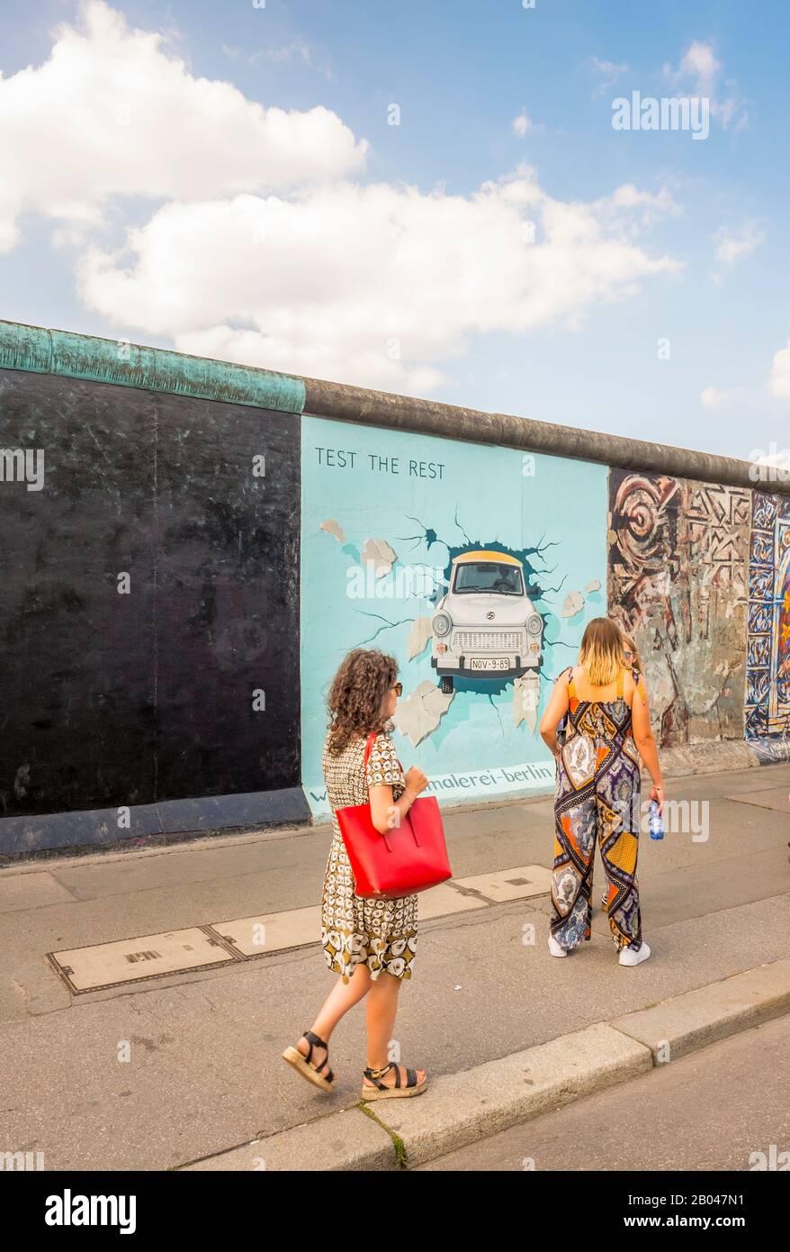 visitors at east side gallery, trabi breaking through wall Stock Photo
