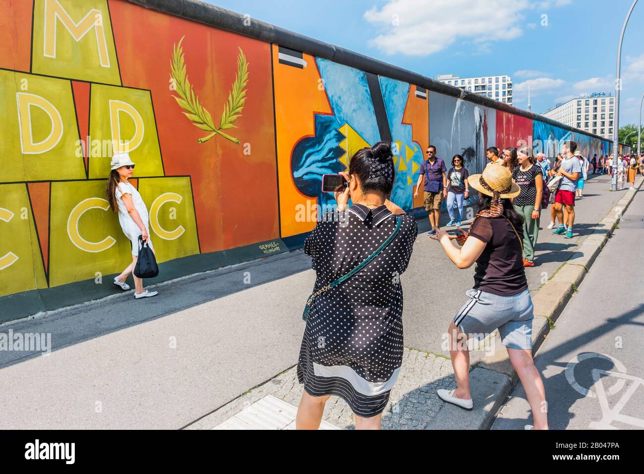 visitors at east side gallery, asian woman posing Stock Photo