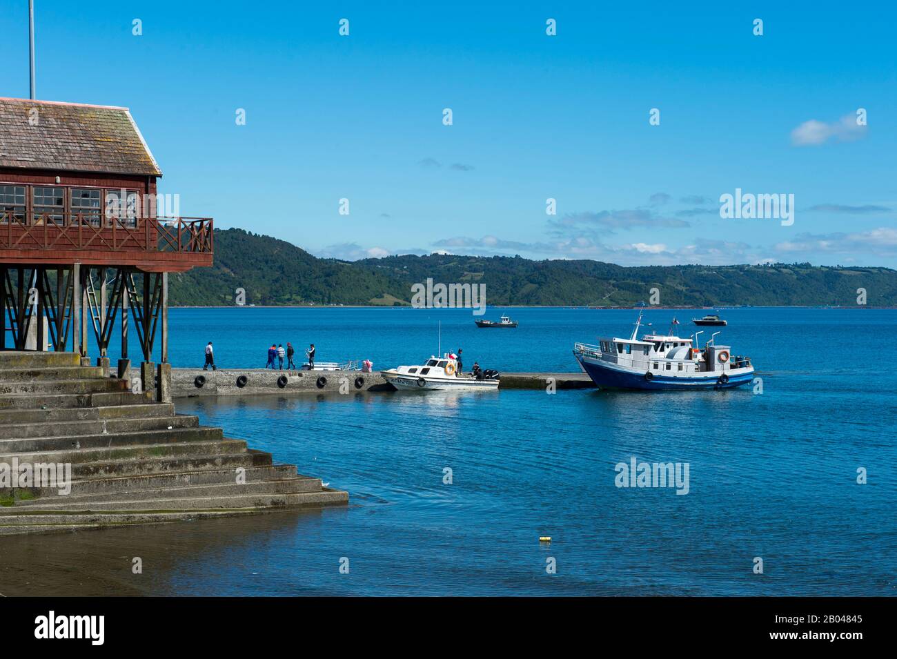 Waterfront with boats in Achao on the island of Quinchao, Chiloe Island, Chile. Stock Photo