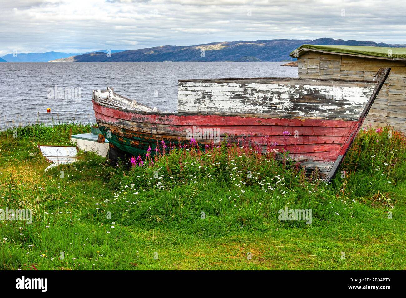 Old wooden boat abandoned artic sea Stock Photo