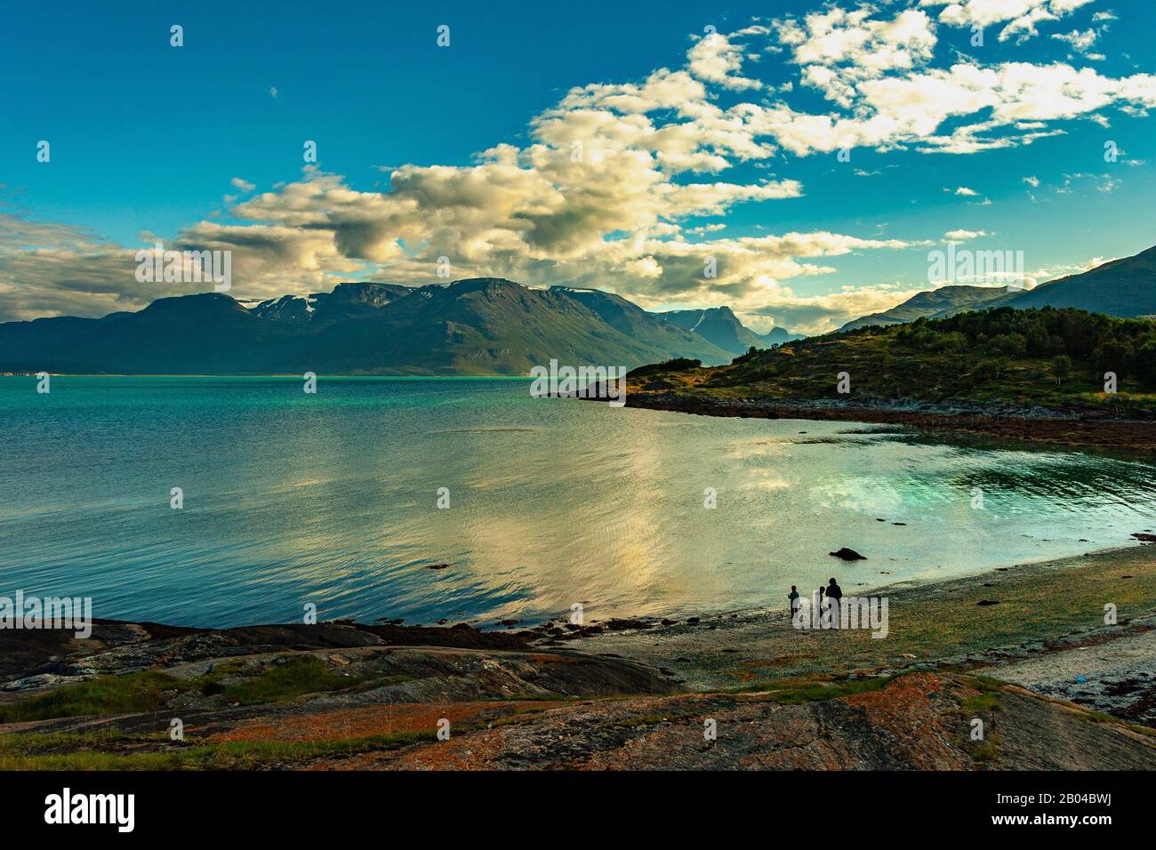 Tourists on the shore of Lyngenfjord, Norway Stock Photo