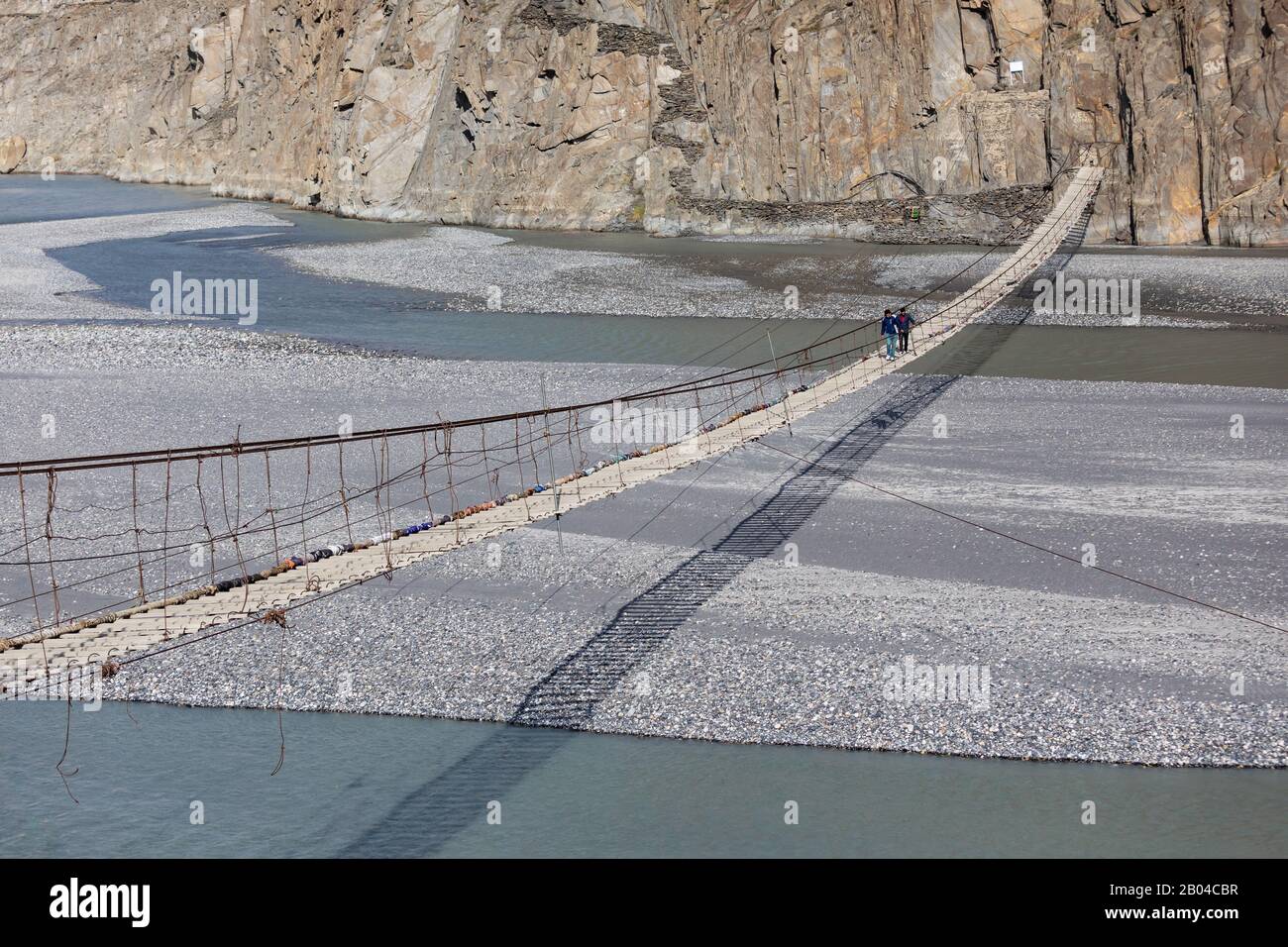 Hussaini suspension bridge passu cones mountain range rocky scenery huzza river gilt baltistan northern areas Pakistan Stock Photo