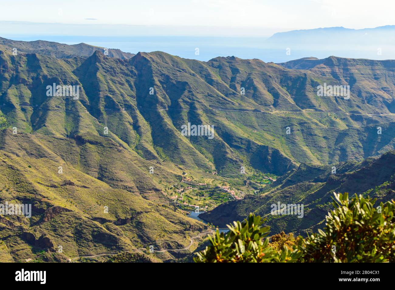 Green Slopes Falling Over The Valley In The Mist Of The Summit In La Gomera. April 15, 2019. La Gomera, Santa Cruz De Tenerife Spain Africa. Travel To Stock Photo