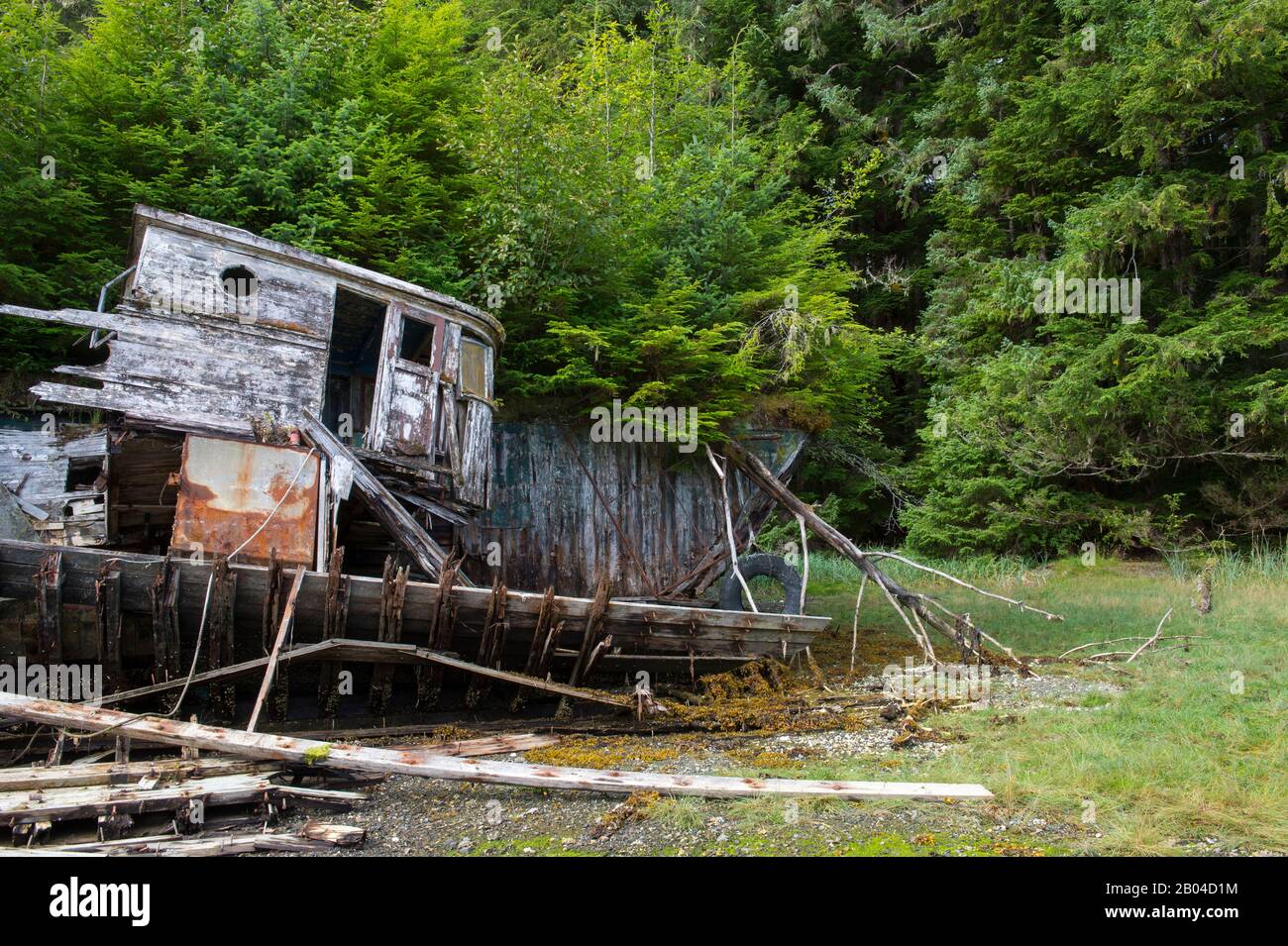 Wrecked wooden boat on beach in Security Bay off Frederick Sound, Tongass National Forest, Southeast Alaska, USA. Stock Photo
