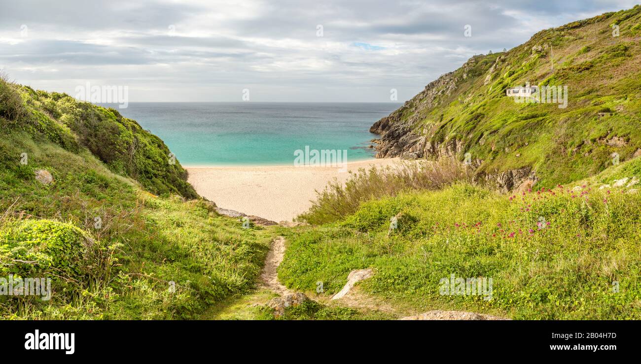 Cloudy Porthcurno Beach with the Minack Open Air Theatre in the background, Cornwall, England, UK Stock Photo