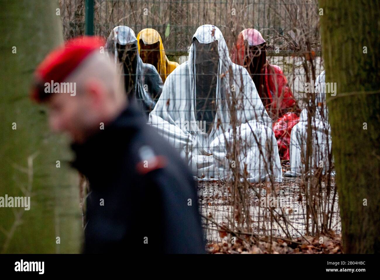 Berlin, Germany. 04th Feb, 2020. "The Guardians of Time" by the Austrian artist Manfred Kielnhofer are standing in the Tiergarten on a fenced area, which a man passes by. Credit: Christoph Soeder/dpa/Alamy Live News Stock Photo