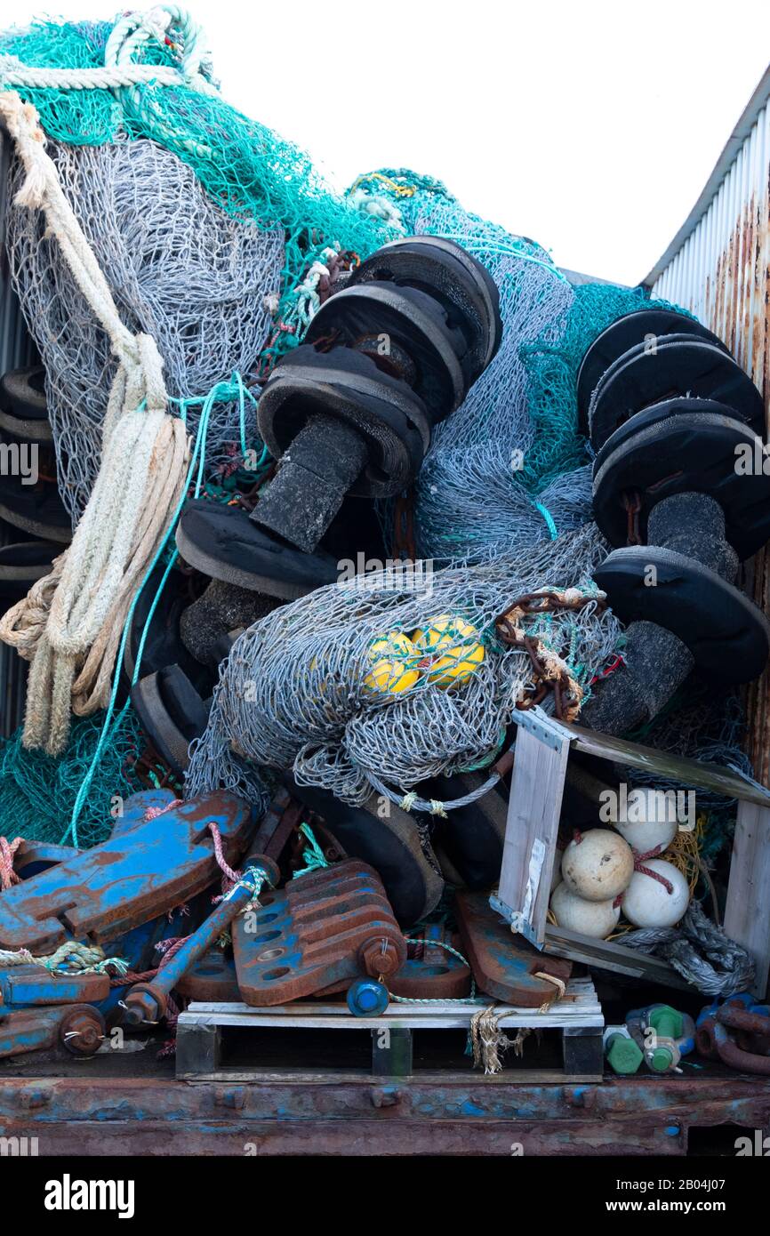 old discarded Fishing nets rope and buoys in shipping Container Stock Photo