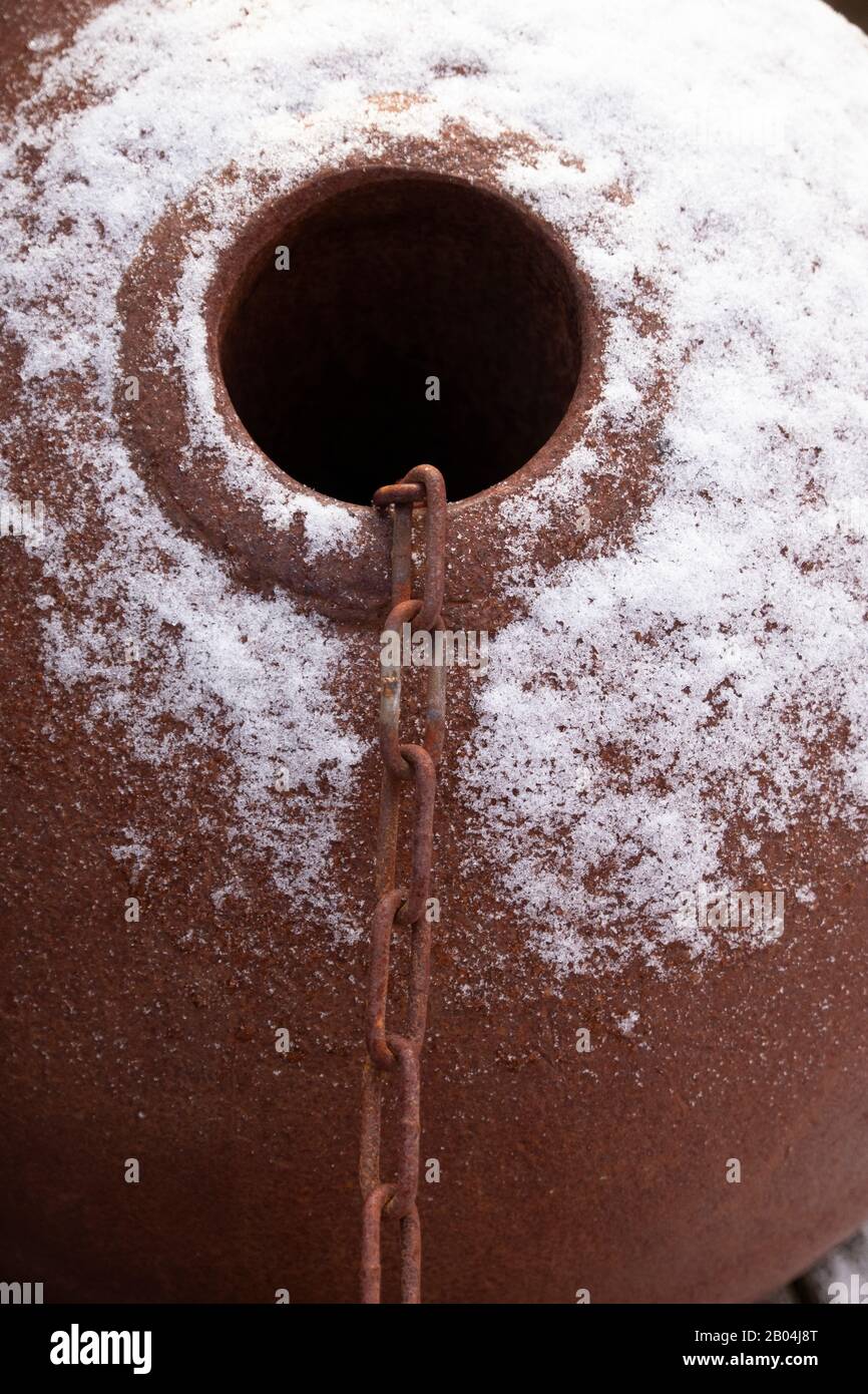 Old rusty metal ships buoy and chain with snow Stock Photo