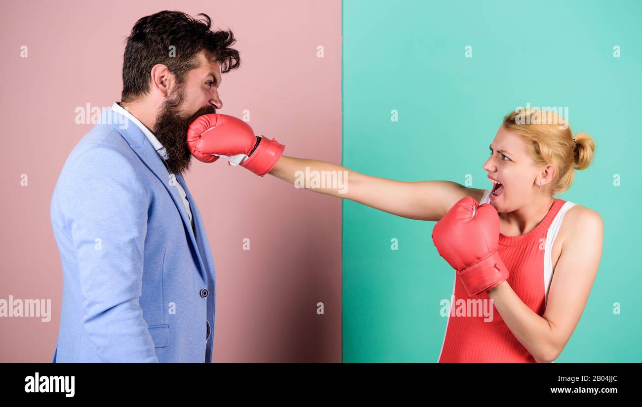Couple in love competing in boxing. Conflict concept. Gender battle. Gender equal rights. Family quarrel. Strong punch. Boxers fighting in gloves. Gender equality. Man and woman boxing fight. Stock Photo