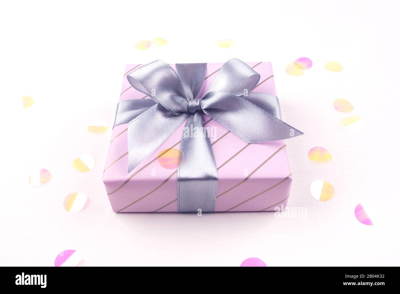 One gift boxe with bow and confetti on a white background Stock Photo ...