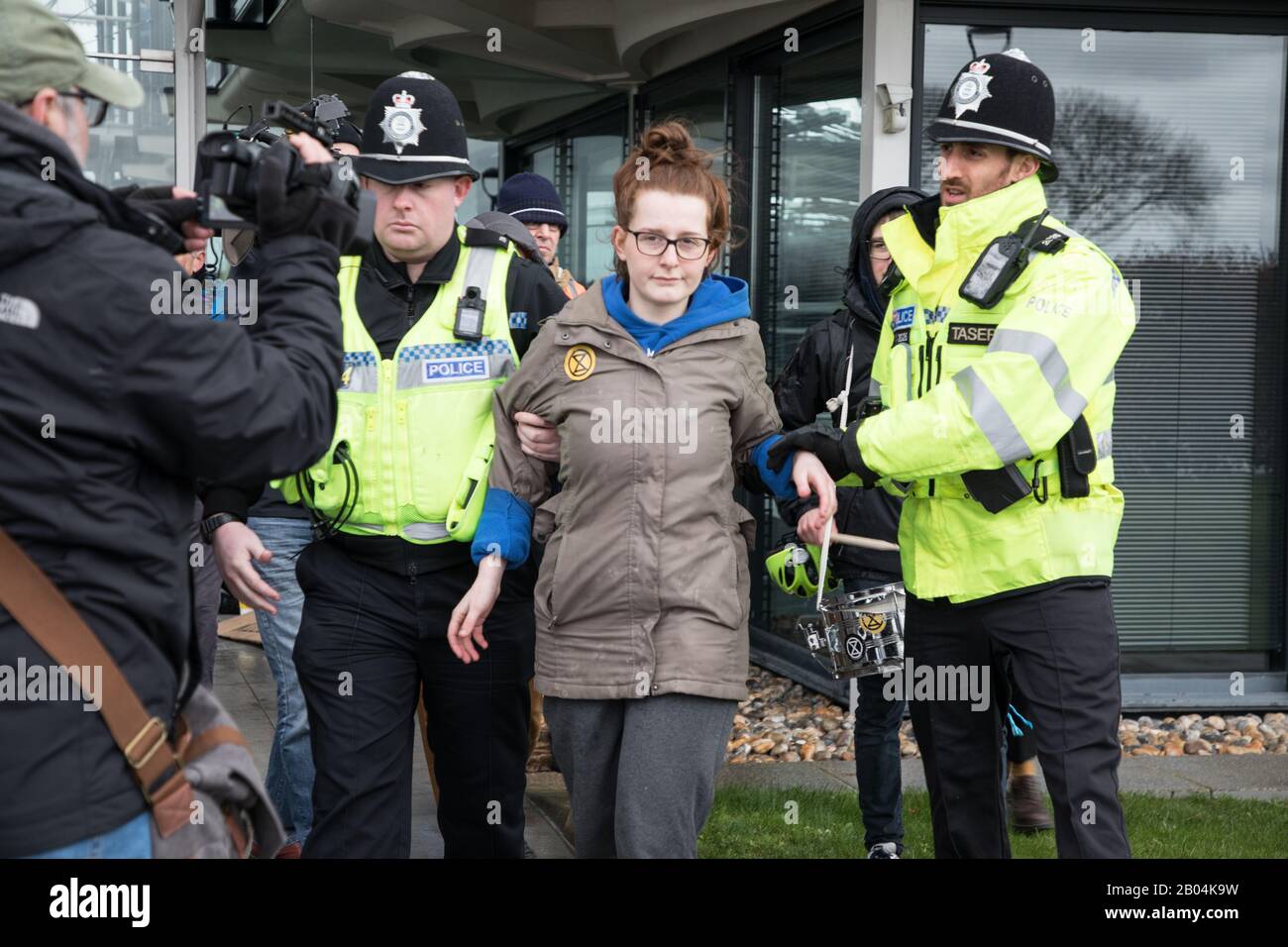 Extinction Rebellion  on 18th February 2020  Protesting at the Schlumberger Building, Cambridge,UK. Protester Gabriella Ditton being arrested. Stock Photo