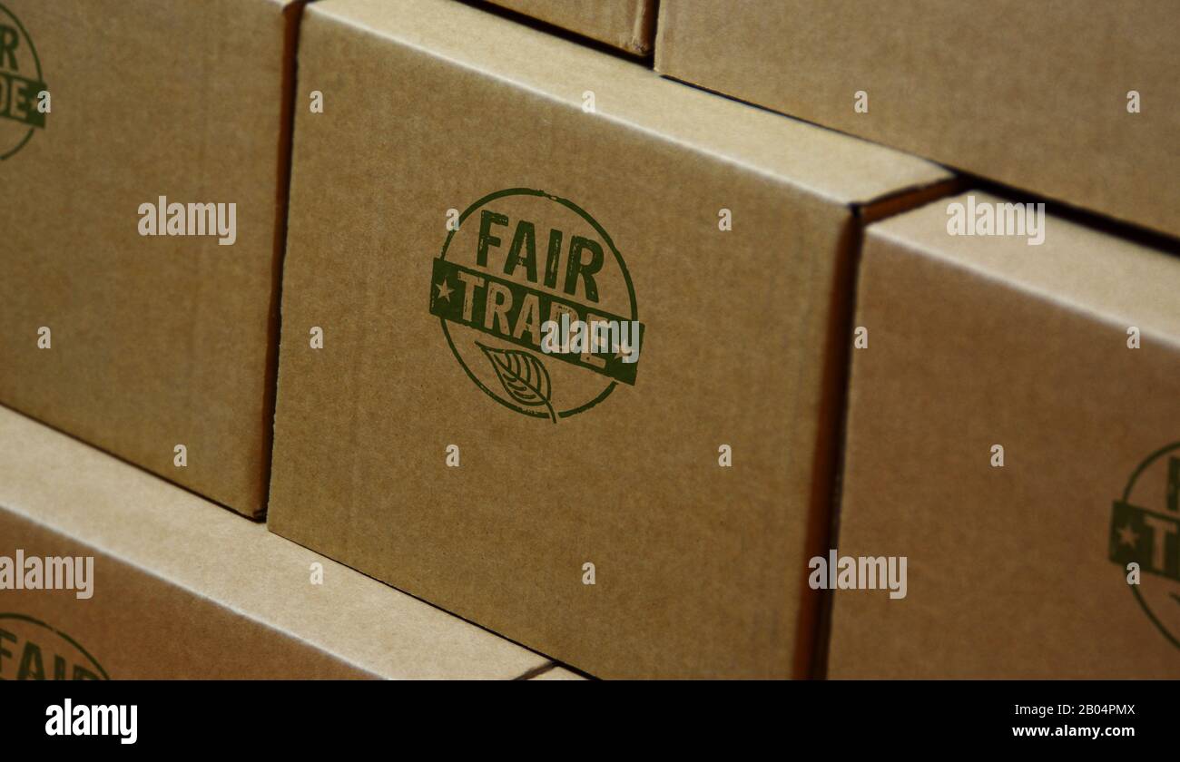 Fair Trade stamp printed on cardboard box. Ethical business, green trade, sustainable economy and environmental care concept. Stock Photo