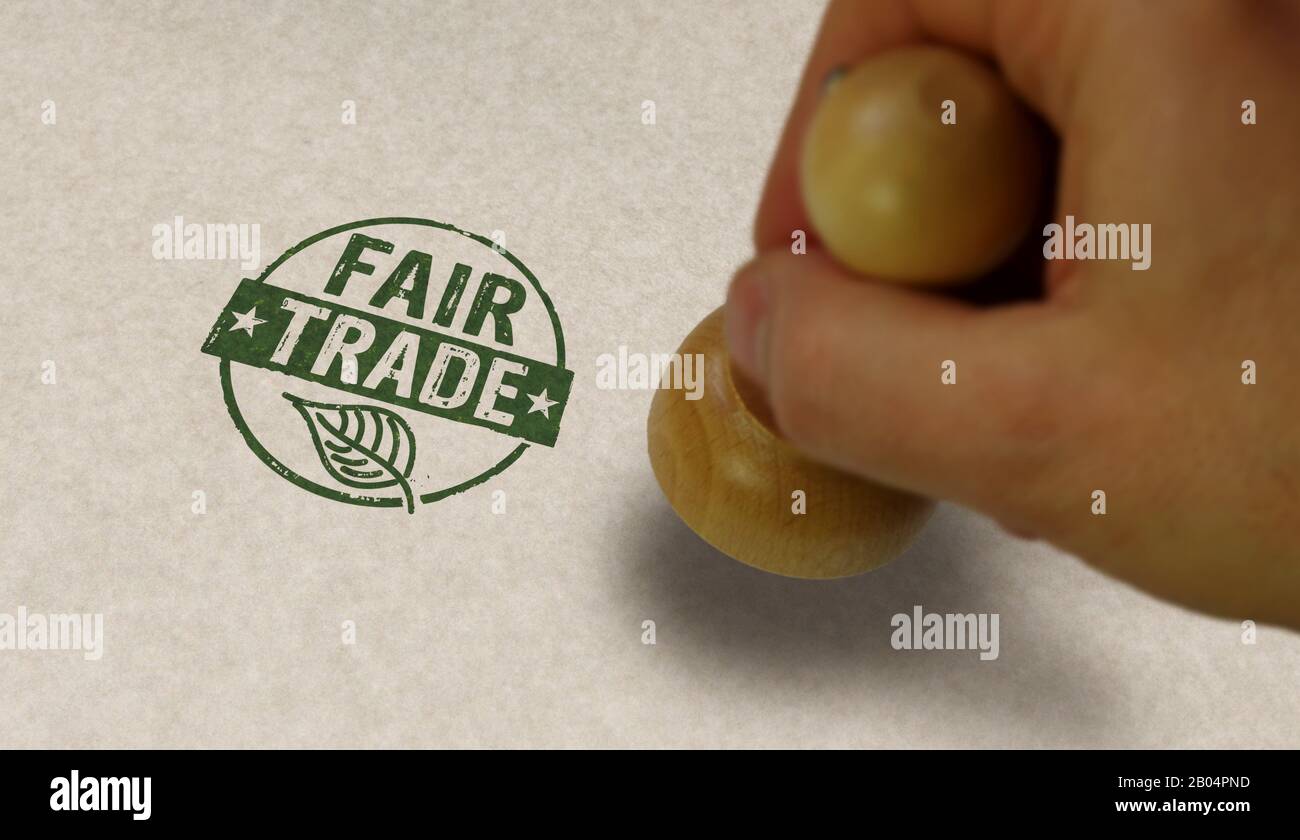 Fair Trade stamp and stamping hand. Ethical business, green trade, sustainable economy and environmental care  concept. Stock Photo