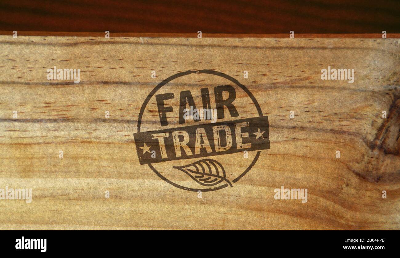 Fair Trade stamp printed on wooden box. Ethical business, green trade, sustainable economy and environmental care concept. Stock Photo