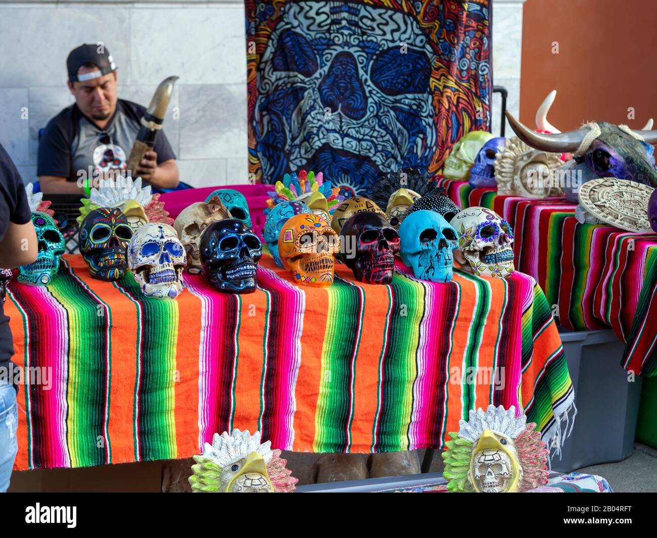 Colorful painted skulls arranged on a vendors table at the 2019 Dia De Los Muertos Festival in downtown Corpus Christi, Texas USA. Stock Photo