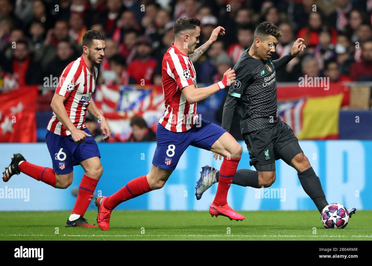 Atletico Madrid's Jorge Koke and Niguez Saul chase Liverpool's Roberto Firmino during the UEFA Champions League round of 16 first leg match at Wanda Metropolitano, Madrid. Stock Photo