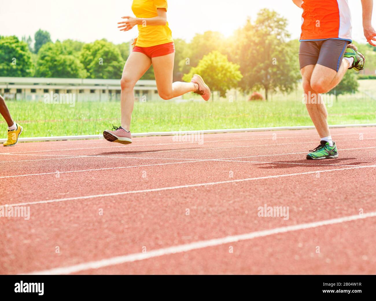Runners athletes speeding in a athletic running track Young people