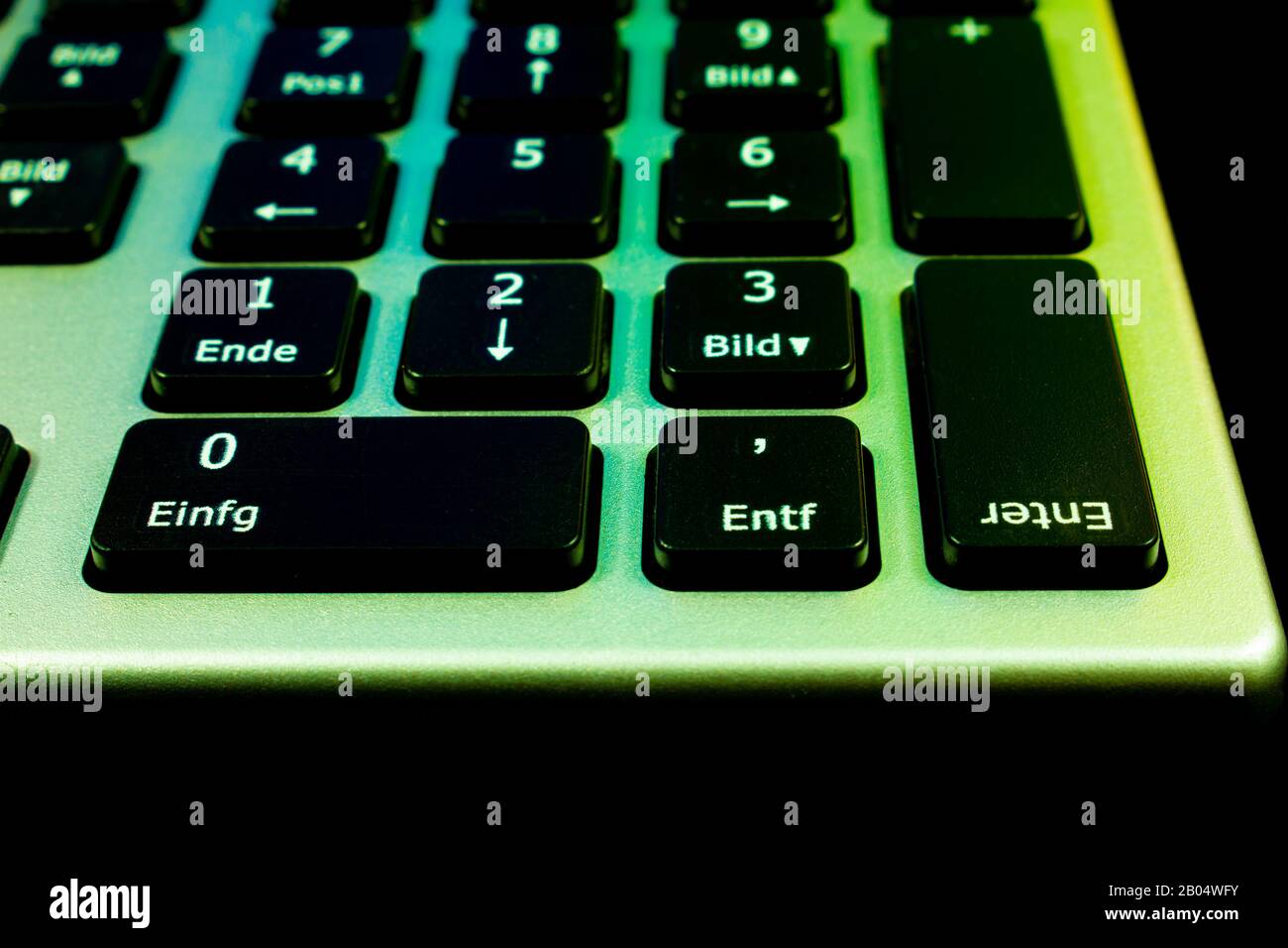 Close up slanted view of computer keyboard with upside down enter key or button. Technical concept for computer doing the opposite that you want. Stock Photo