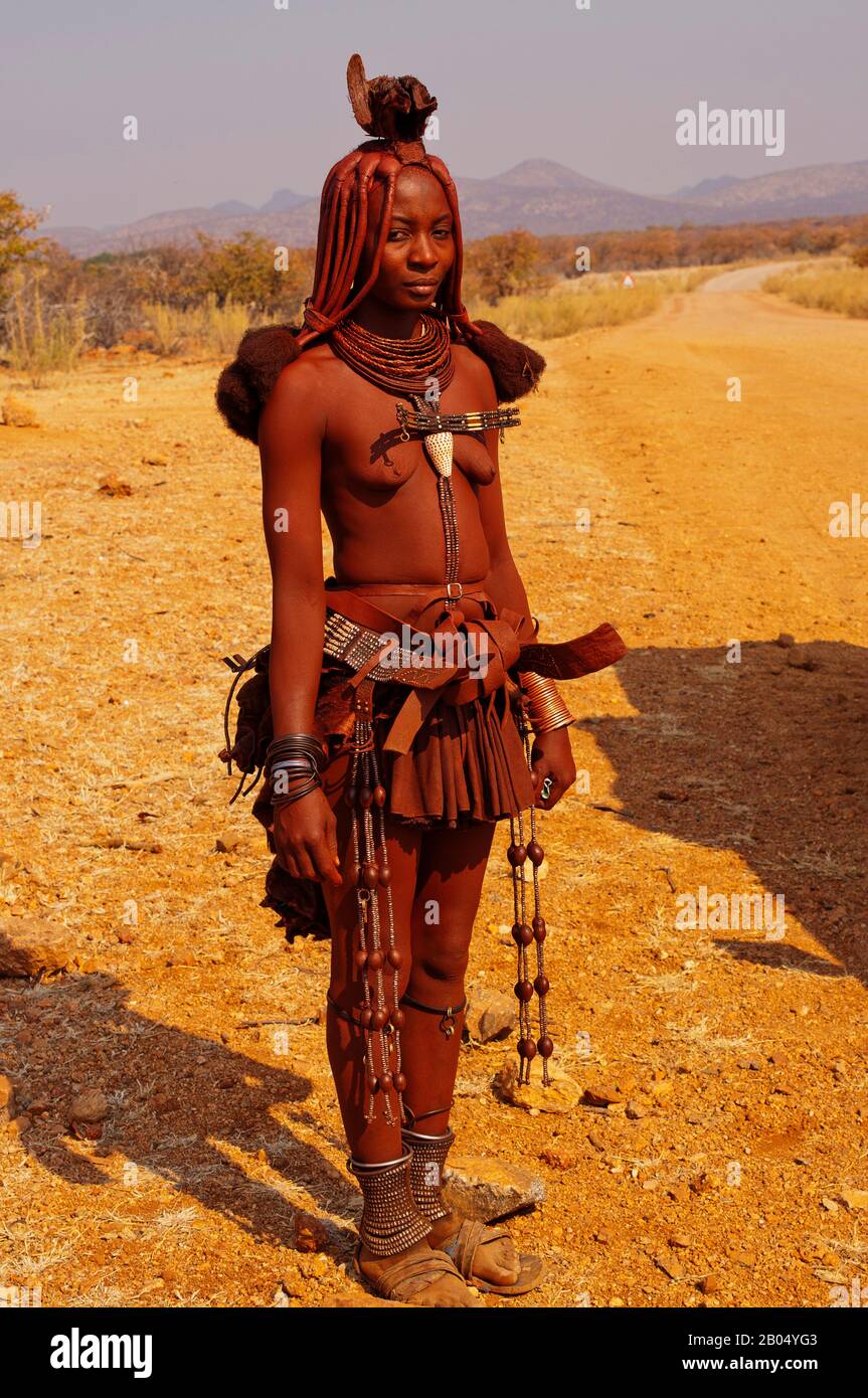 Himba woman in traditional clothes near Epupa Falls, Kunene Region, Namibia Stock Photo