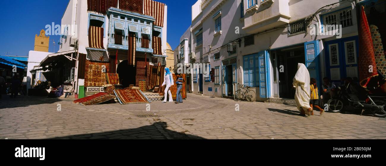 Four people walking on the street, Medina, Kairwan, Tunisia Stock Photo