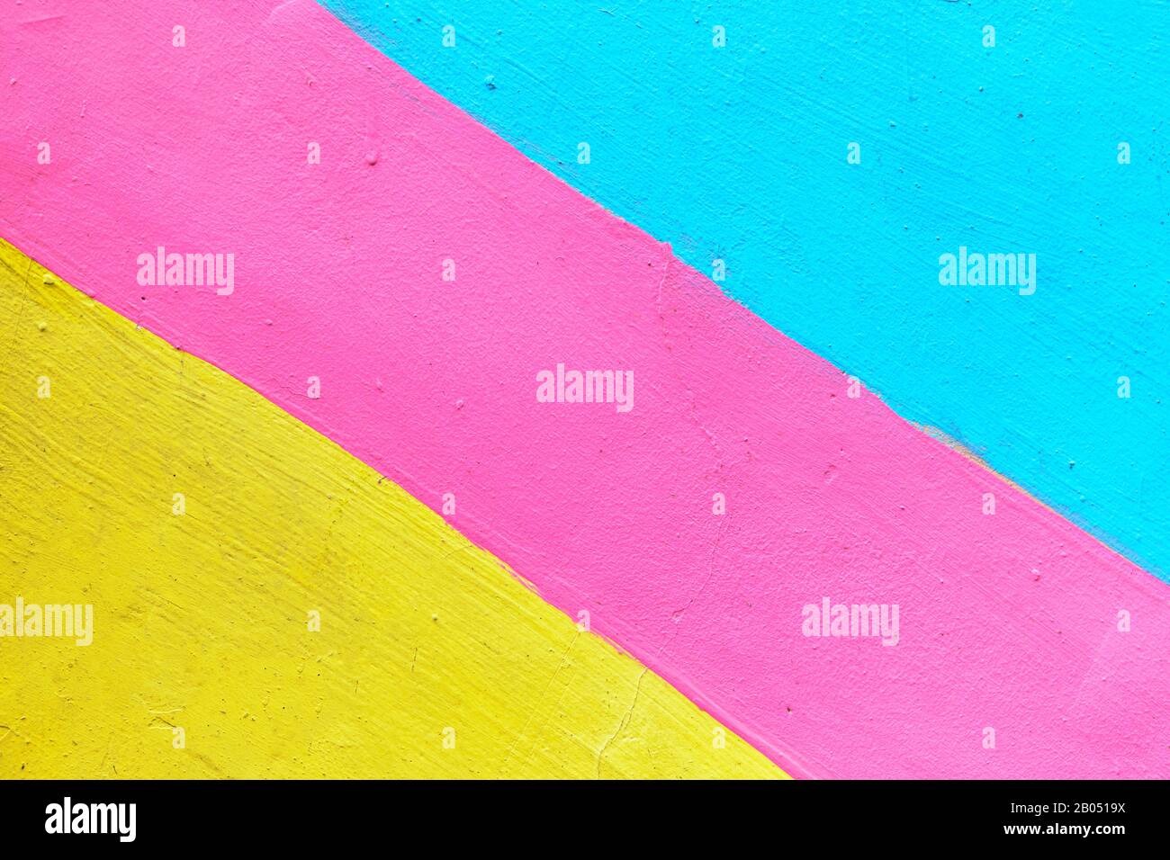 Abstract texture of plaster light blue and yellow with pink-colored line. Close up. Stock Photo