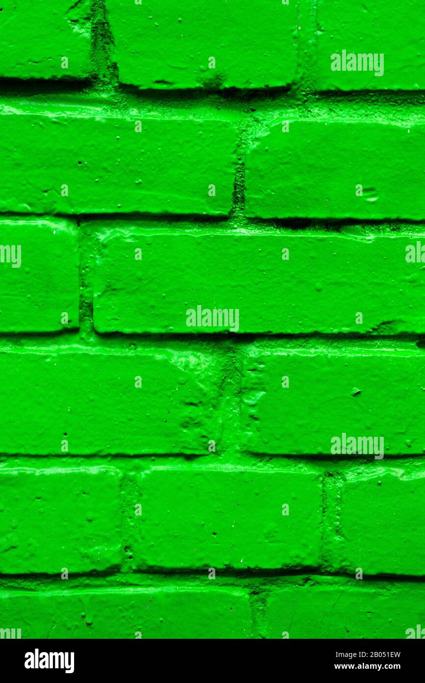 Brick wall as a texture painted in green. Vertical. Stock Photo