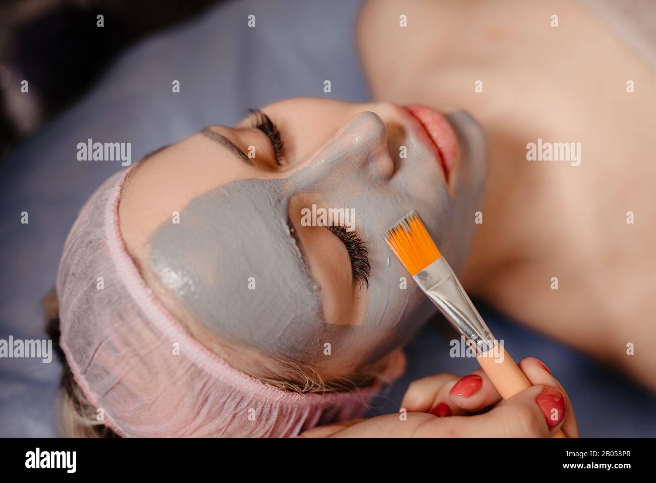 Spa Mud Mask. Woman in Spa Salon. Face Mask. Facial Clay Mask. Treatment Stock Photo