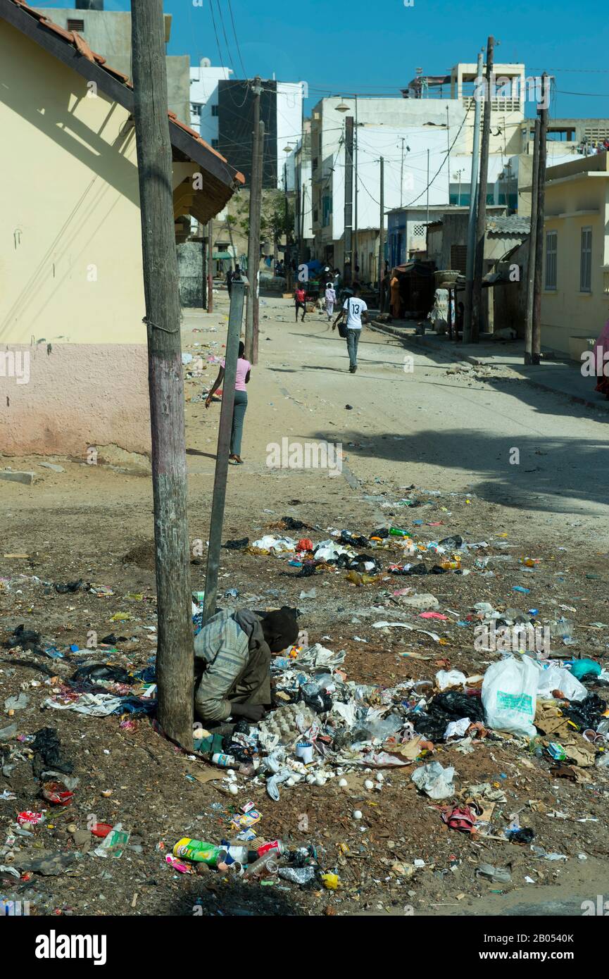 Poor man sifting through garbage for food in Dakar, Senegal, West Africa Stock Photo
